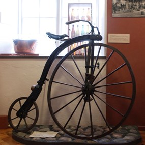 en gammal cykel med ett stort och ett litet hjul